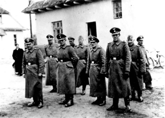 This photo made available by Yad Vashem Photo Archive in Jerusalem shows Nazi guards at Belzec death camp in occupied Poland in 1942. A former Nazi death camp guard has been charged with participating in the murder of 430,000 Jews and other crimes during the Third Reich,